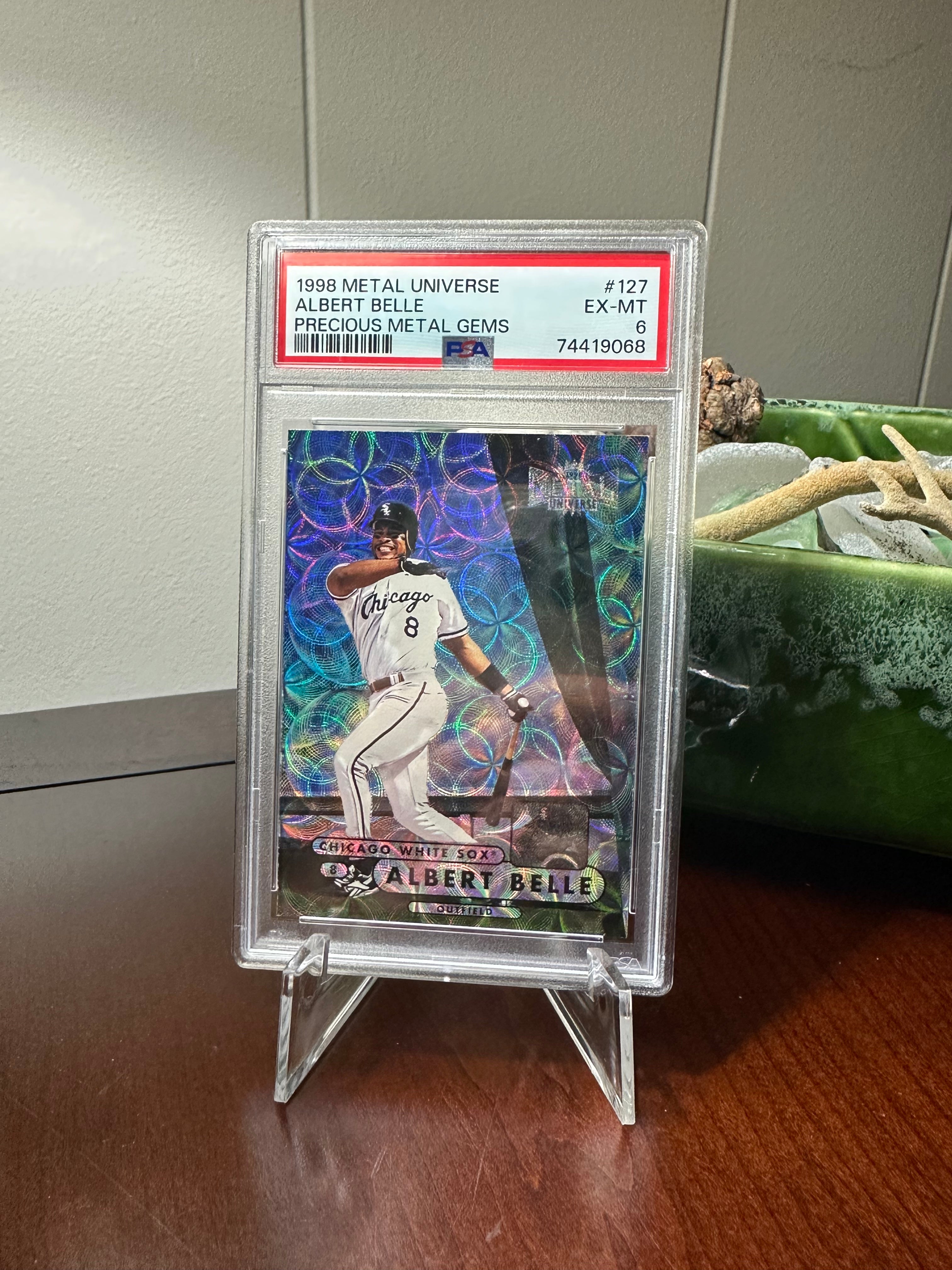 Trading card of Albert Belle graded PSA 6 on a cheap plastic tripod stand.