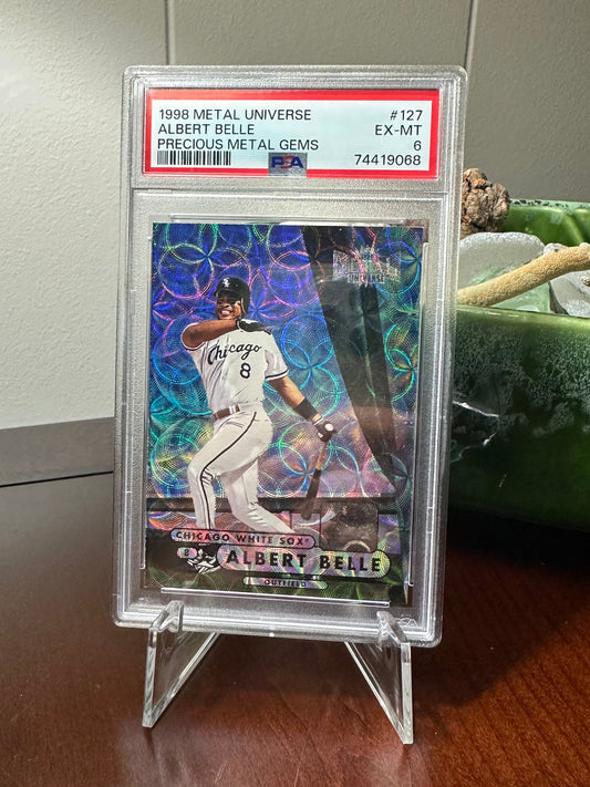 Trading card of Albert Belle graded PSA 6 on a cheap plastic tripod stand.