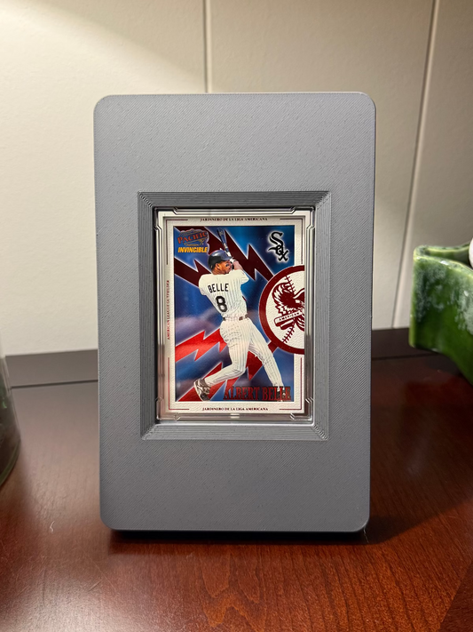 Framed baseball card of Albert Belle of the Cleveland Indians, Chicago White Sox, and Baltimore Orioles in a gray SlabGhost Raw frame on a wooden surface.