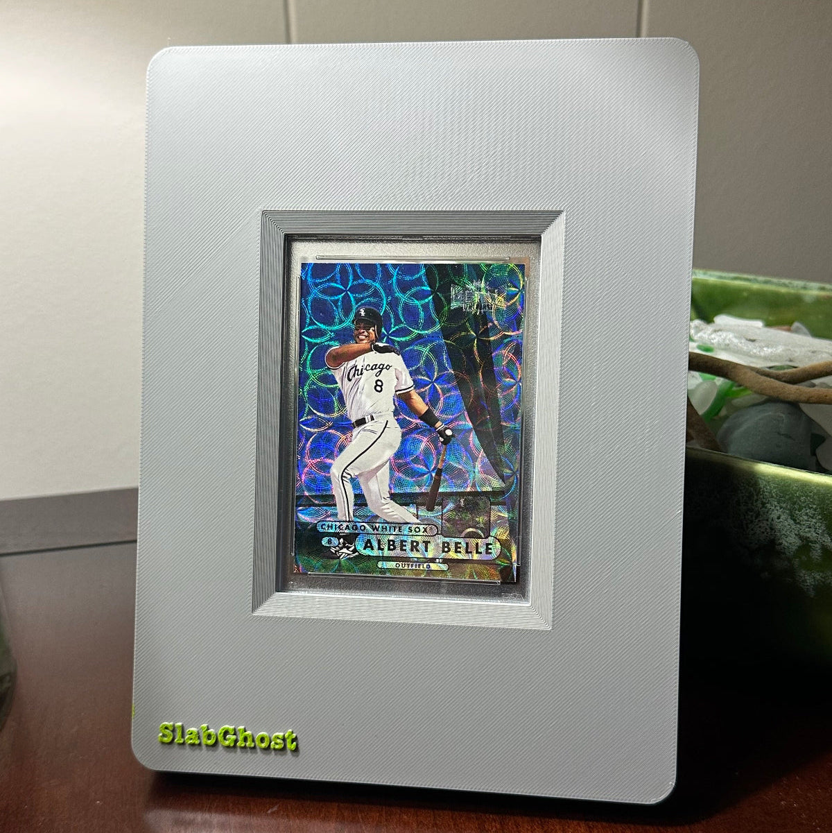 1998 Metal Universe Albert Belle Precious Metals Gems (PMG) baseball trading card in an undisclosed PSA grade, framed in a grey SlabGhost display case.