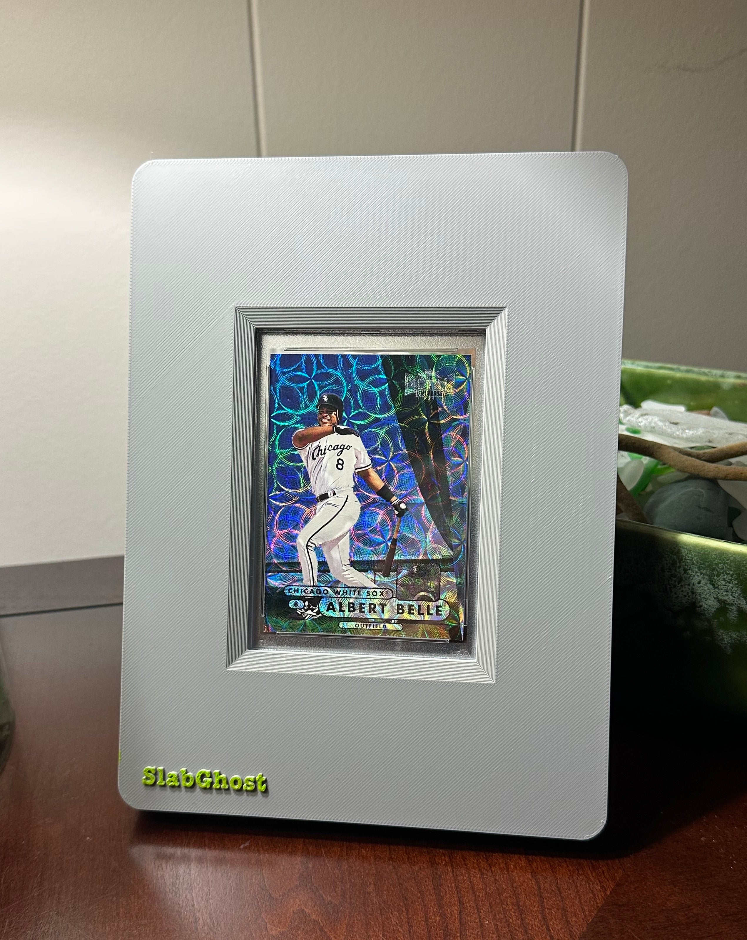 1998 Metal Universe Albert Belle Precious Metals Gems (PMG) baseball trading card in an undisclosed PSA grade, framed in a grey SlabGhost display case.